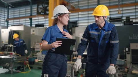 Two workers in a factory setting Stock Footage 341925647