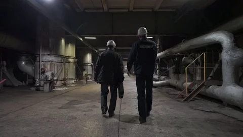 Two workers go on factory. Engineers in production hall Stock Footage 106966902