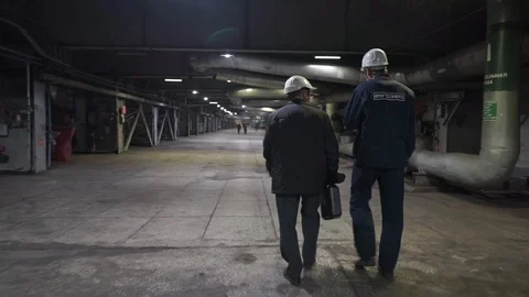 Two workers go on factory. Engineers in production hall Stock Footage 106966917