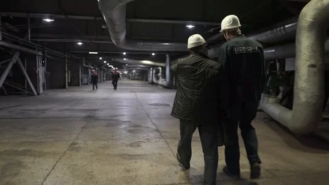Two workers go on factory. Engineers in production hall Stock Footage 106966934