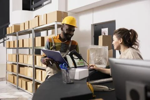 Two workers handling quality control operations and checking inventory Stock Photos
