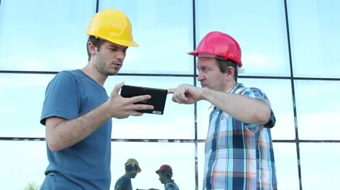 Two workers with helmets talking Stock Footage 58891257
