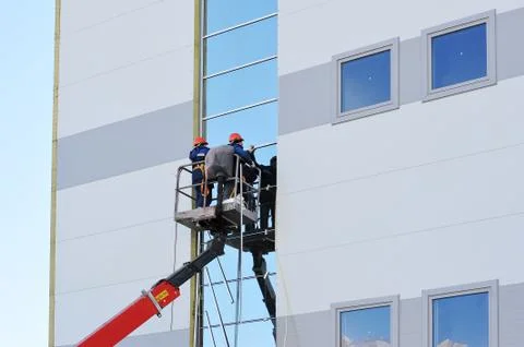 Two workers on the lift platform Stock Photos