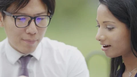 Two workers looking at something on a mobile phone Stock Footage 77101991