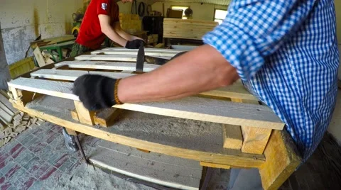 Two workers make pallet. hammer in nails. Stock-Footage 52004155