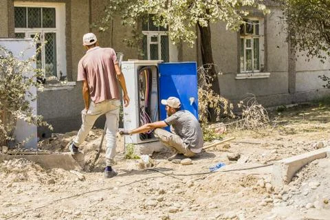 Two workers make wiring in the dashboard Uzbekistan,Tashkent August 07.08.2020 Stock Photos