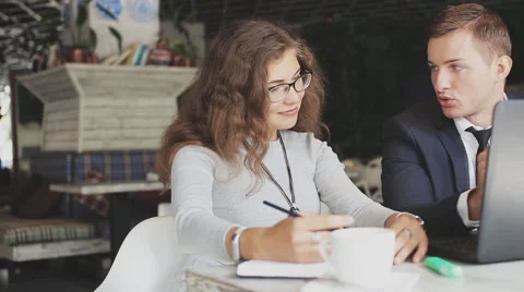 Two workers with modern laptop in cafe Stock Footage 67381439