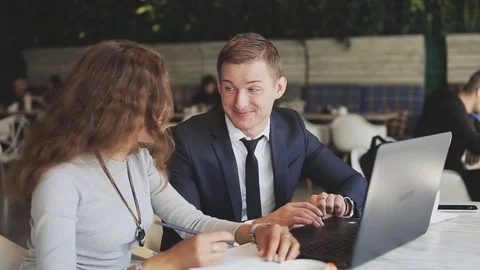 Two workers with modern laptop in cafe Stock Footage 70451354
