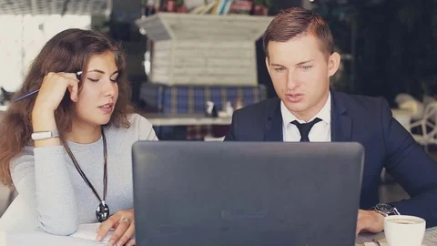 Two workers with modern laptop in cafe Stock Footage 73421635