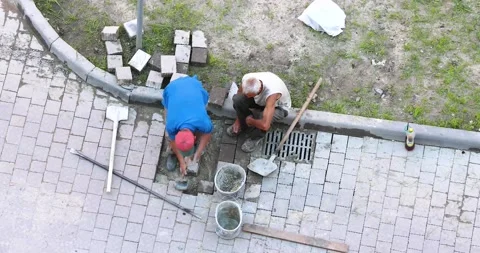 Two workers negligently make the road paved Stock Footage 137086670