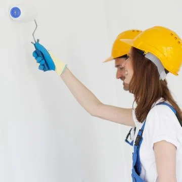 Two workers painting the wall Stock Photos