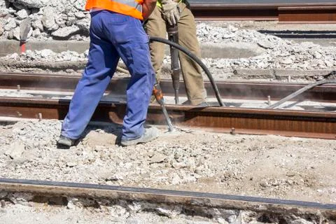 Two workers with pneumatic hammer Stock Photos