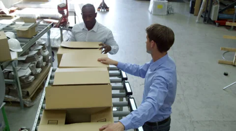 Two workers preparing and stacking consignment boxes Stock Footage 32933202