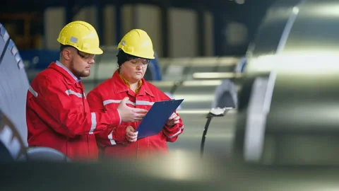Two workers in production plant as team discussing, industrial scene in Stock-Footage 85487666