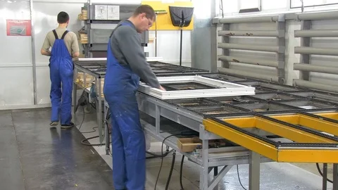 Two workers in the production of plastic windows Stock Footage 103372965