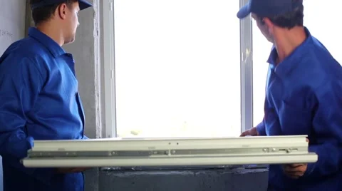Two workers put window sash into new installed frame. Stock-Footage 50282539