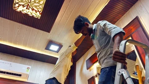 Two Workers Renovate Wooden Ceiling in Modern Interior Stock Footage 313277736
