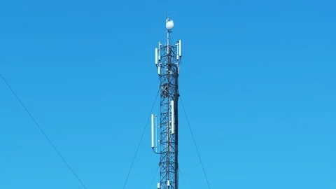 Two workers repair cell tower. High-altitude work. Laying new cables Stock Footage 310737822