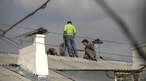 Two workers repairing the vent pipe on the roof Stock Footage 62475026