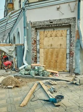 Two workers reparing the old building Stock Photos