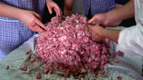 Two workers season pork meat to make sausages Stock Footage 165540160