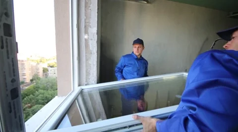 Two workers set window to new installed window-frame. Stock Footage 50282562