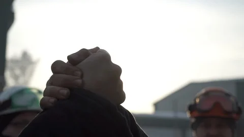 Two workers shake hands at the factory Stock Footage 104851727