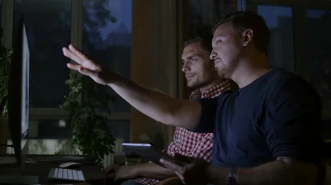 Two workers sit at office and discuss constructions of the house Stock Footage 58014304