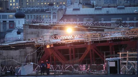 Two workers smoke at a construction in the evening in the Moscow Stock Footage 60233413