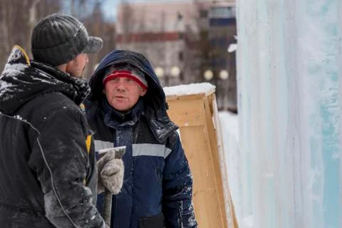 Two workers talk on the assembly site 写真素材