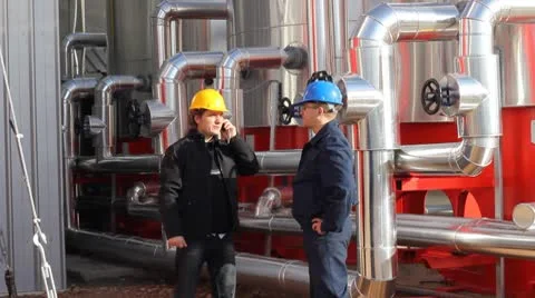 Two workers talking in a factory Stock Footage 8945605