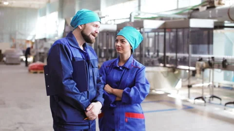 Two workers talking in factory Stock Footage 96349775