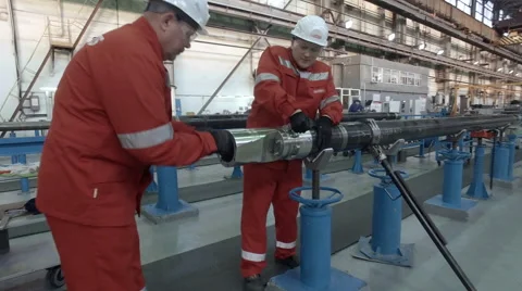 Two workers tighten the pipe Stock Footage 62085972