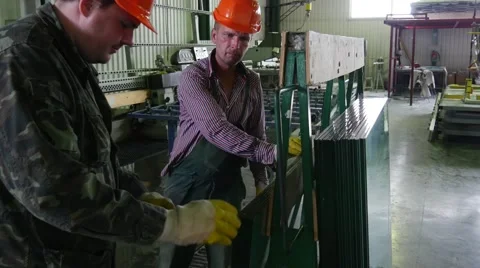 Two Workers in Uniform And Orange Safety Helmets, Yellow Gloves, Have Took the Stock Footage 52870112