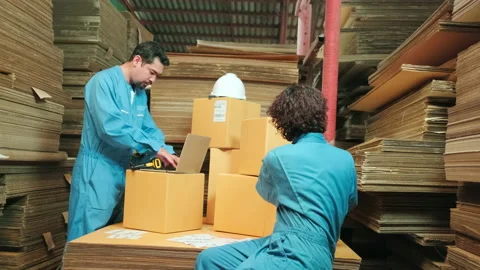 Two workers use a bar code scanner to check orders stock at parcels warehouse. Stock Footage 170803042