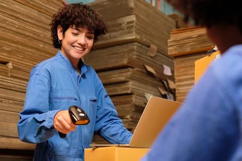 Two workers use a bar code scanner to check orders stock at parcels warehouse Stock-Fotos