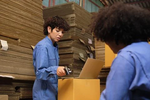 Two workers use a bar code scanner to check orders stock at parcels warehouse Stock-Fotos