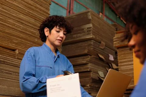 Two workers use a bar code scanner to check orders stock at parcels warehouse Stock Photos