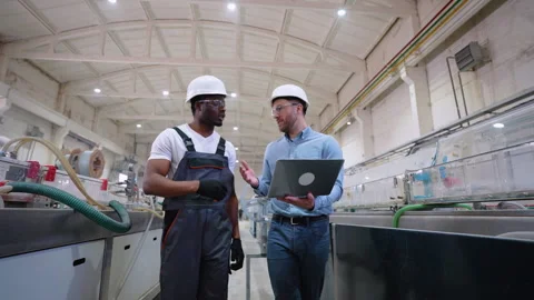 Two workers walking and check the cooling system of the production line Video stock 270105175