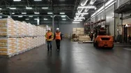 Two Workers Of Warehouse Team Discussing While Walking In Warehouse. Aerial, Top Stock Footage