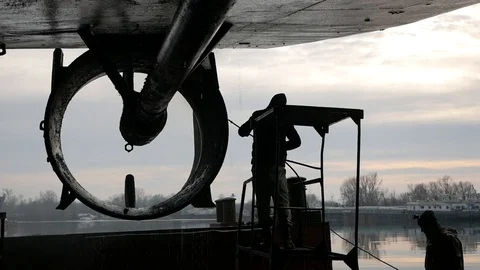 Two workers wash the ship's hull in the dock, against the sky Stock Footage 87505553
