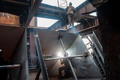 Two workers while doing a industrial welding Stock Photos