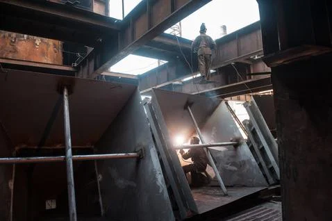 Two workers while doing a industrial welding Stock Photos