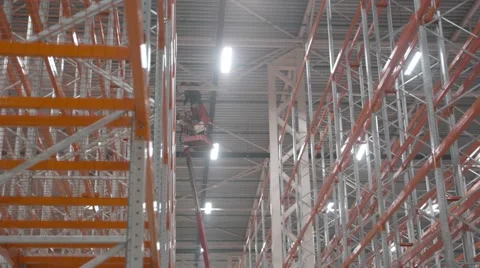 Two workers working on the crane inside a new modern warehouse Video stock 61894300