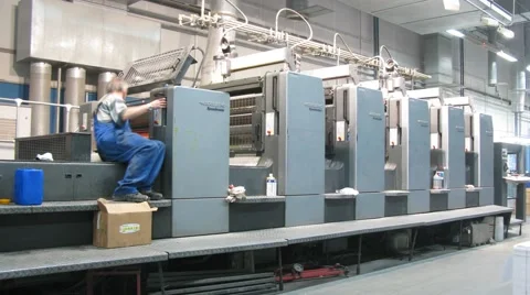 Two workers working in printing presses in Printing Complex Stock Footage 49570589