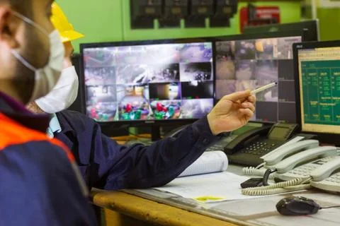 The two workers with yellow helmets in control panel in the laboratory Stock Photos