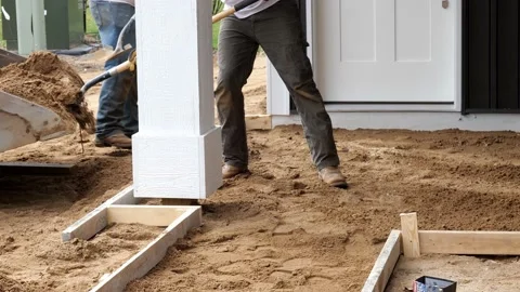 Two working men shovel dirt for a new cement concrete sidewalk. Stock Footage 154665915