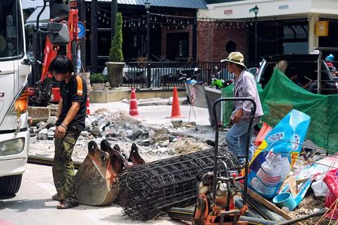 Two working Thai men on a construction site Stock Photos