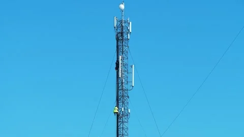 Two workmen on a cell tower. Maintenance staff at the work. High-altitude works Stock Footage 314341920