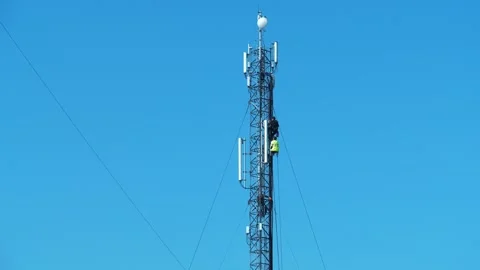 Two workmen on a cell tower. Maintenance staff at the work. High-altitude works Stock Footage 318960952